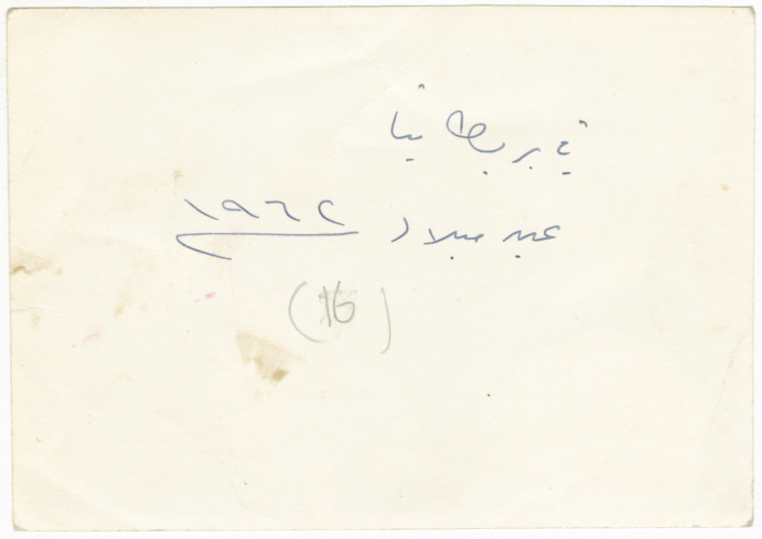 A Photograph of a Palestinian Man Holding a Bottle of an Alcoholic Drink