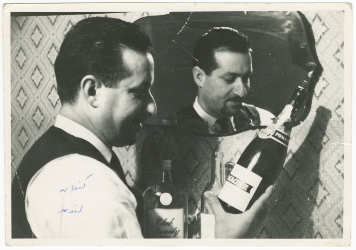 A Photograph of a Palestinian Man Holding a Bottle of an Alcoholic Drink