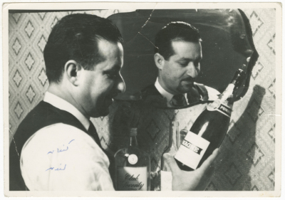 A Photograph of a Palestinian Man Holding a Bottle of an Alcoholic Drink