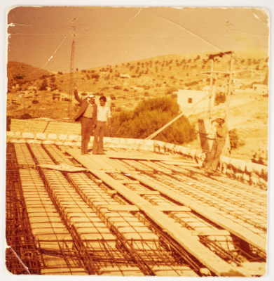 Musa Sanad Atop a Roof During Construction 