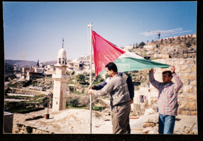 Flying the Palestinian Flag at the Folklore Life Exhibition in Artas 