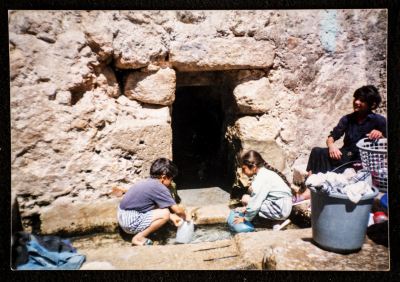 A Lady With Her Children Washing Clothes Near a Spring in Artas