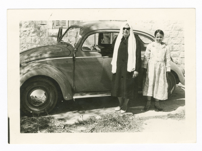 A Mother and Her Daughter in Front of a Car