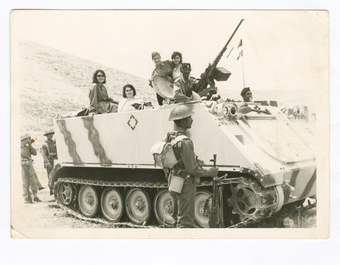 A Photograph of Haifa Irshaid with Colleagues Atop a Tank, First Aid Course 