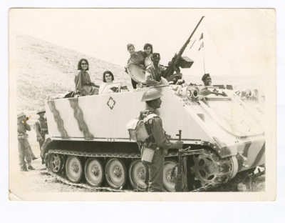 A Photograph of Haifa Irshaid with Colleagues Atop a Tank, First Aid Course 
