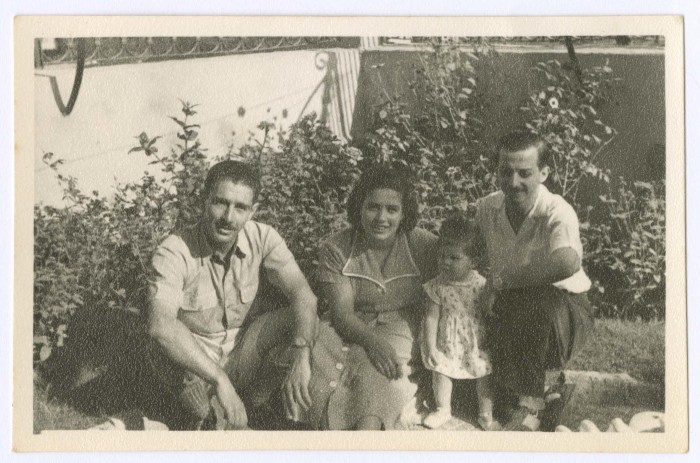 A Photograph of a Group of People in a House Garden