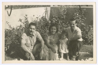 A Photograph of a Group of People in a House Garden