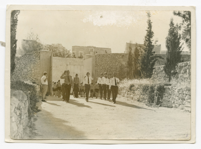 A Photograph of Members of the Papal Scout Troop of Beit Jala Marching in Line