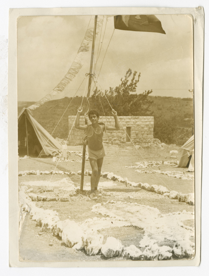A Photograph of a Scout Member in Front of a Flagpole
