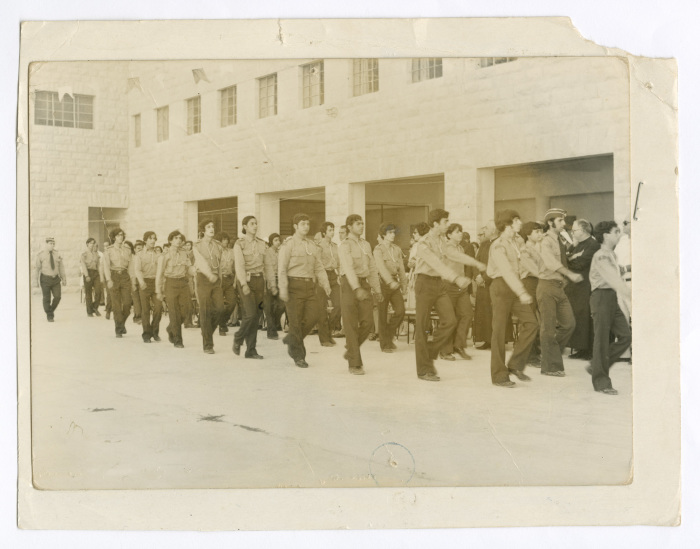 A Photograph of Scout Members Marching in Line