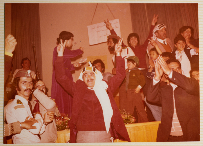 A Photograph of Karim Khalaf Raising the Victory Sign Surrounded by a Crowd During a Reception Held in Beit Sahour