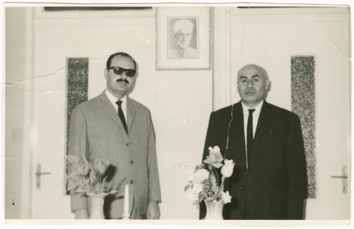 Siblings with their father's photo