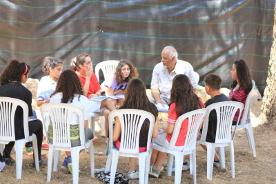 A Photograph of Director Fathy Abder-Rahman with Children at a Summer Camp, 2011 