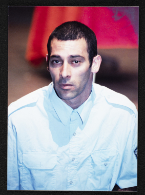A Photograph of Ashraf Barhum During the Theatrical Performance "Buʾs Wa Ruʿb Reich ath-Thaleth"