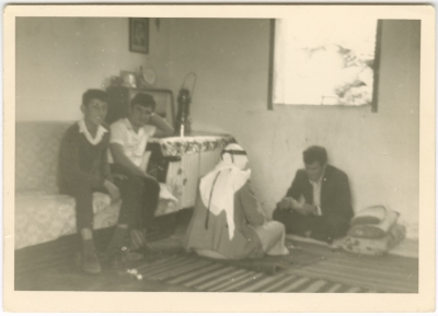 A man from the Asala family and another from the Ahmad family are playing cards.