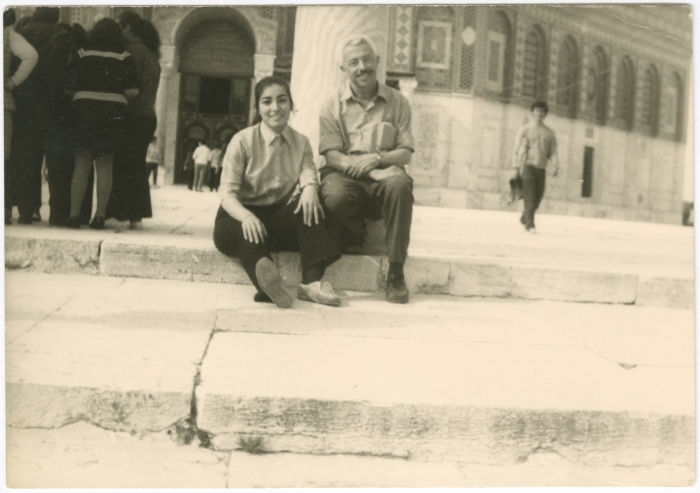 A girl from the Naamneh family and a teacher from the family of Araf are sitting in the courtyard of the Al-Aqsa Mosque