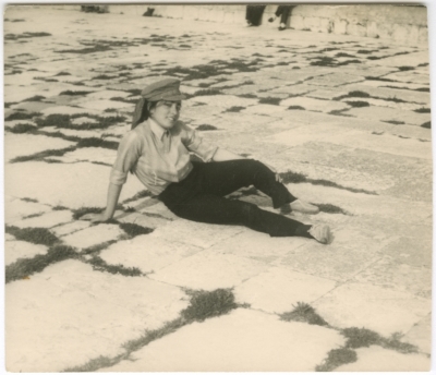 A girl from the Naamna family sits on the ground at the Al-Aqsa Mosque