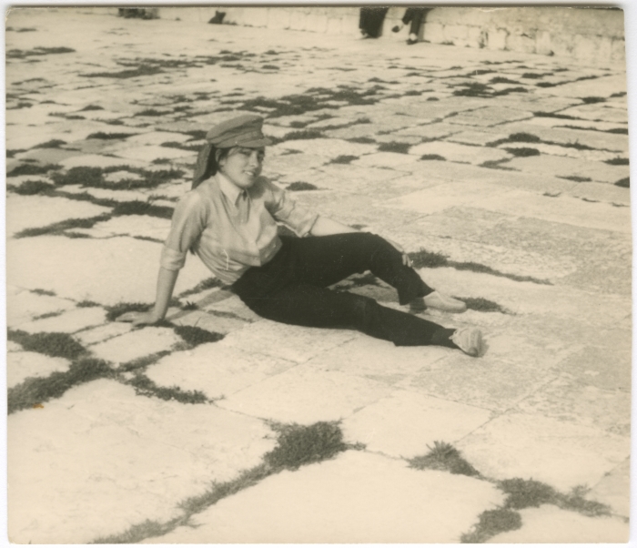 A girl from the Naamna family sits on the ground at the Al-Aqsa Mosque