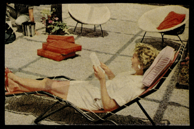 A Photograph of a Woman Sitting in the Outdoors 