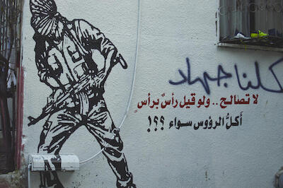 A Patriotic Slogan and Model of a Fighter on a Wall in Dhiesheh Camp