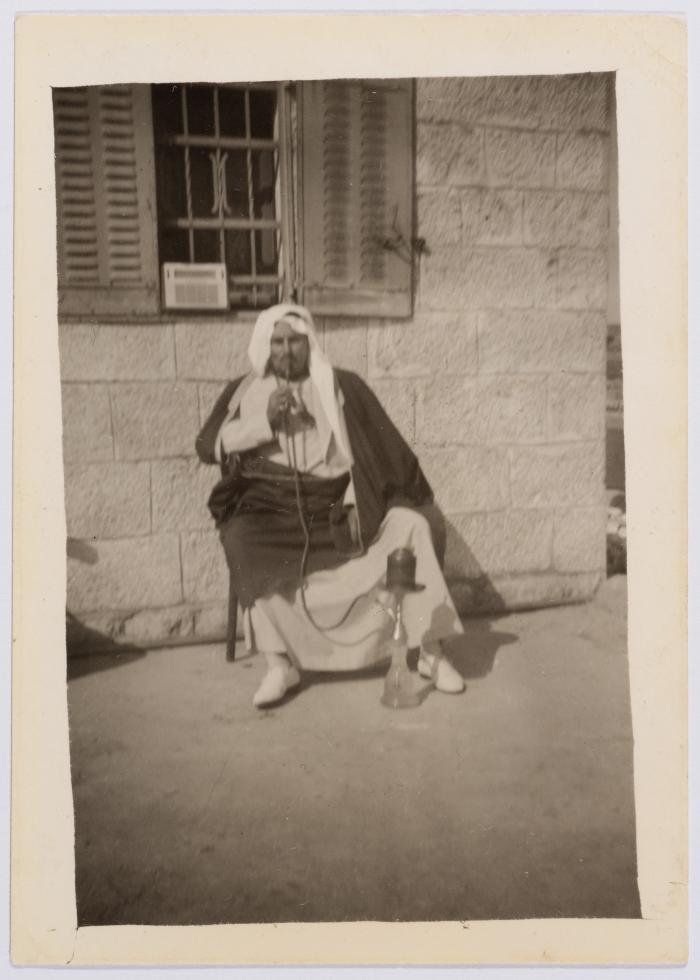 A Photograph of Ibrahim abu Sitteh Smoking a Hookah in Front of His House in Deir Jarir, Ramallah 