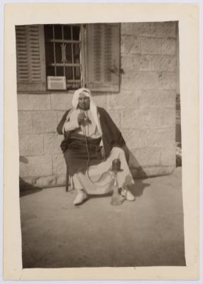 A Photograph of Ibrahim abu Sitteh Smoking a Hookah in Front of His House in Deir Jarir, Ramallah 