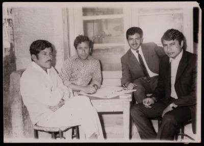 Ali Fodeh with Men Seated at a Round Table