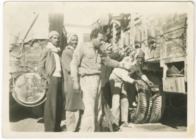 ʿali ʿubayd with Other Men Pushing a Sunken Truck in Qatar