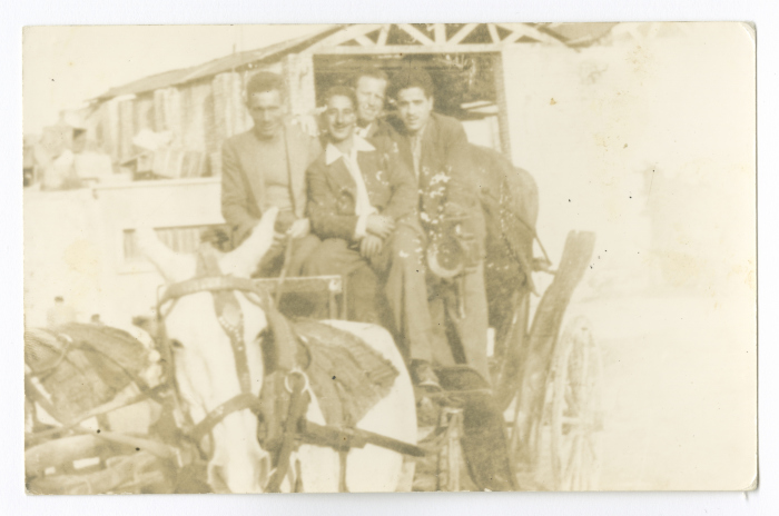 Men Riding a Horse-Drawn Wagon in Baghdad
