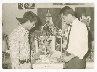 ʿabdel-ʿaziz Misk and a Student Examine the Artworks and Art Education Exhibition 