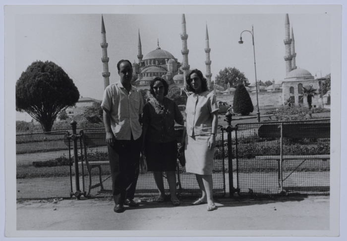 A Photograph of Two Girls and a Man