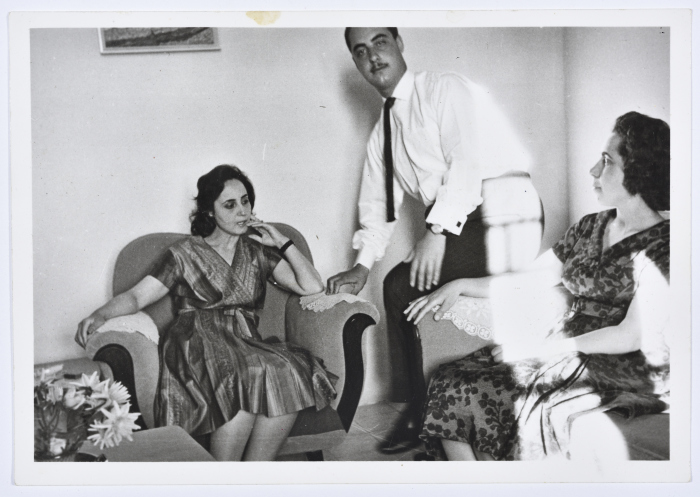 A Photograph of Two Girls and a Man