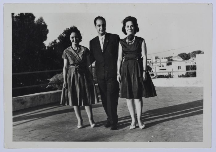 A Photograph of Two Girls and a Man