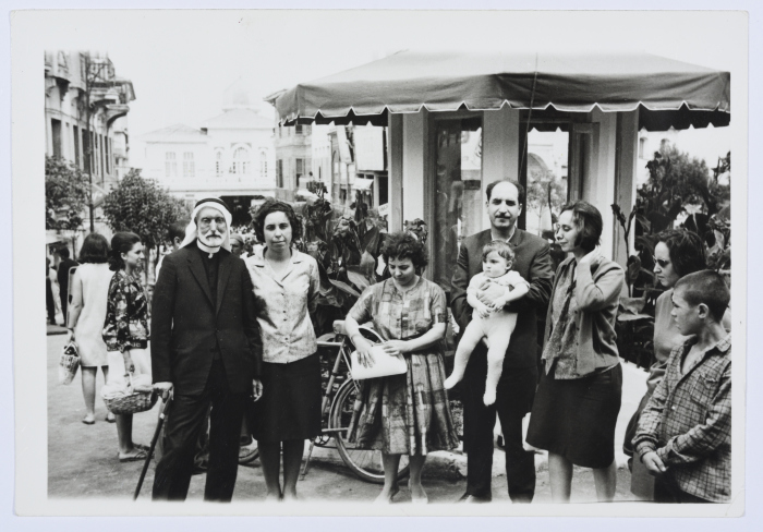 A Photograph of Two Girls and Several Men