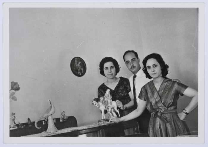 A Photograph of Two Girls and a Man