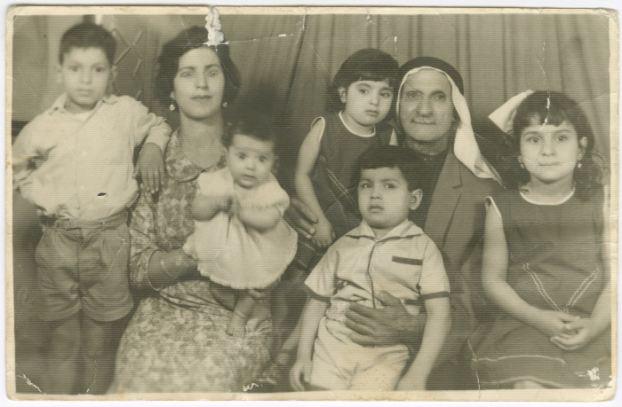 A memorial photo of a grandfather with the wife of his son, and his grandkids