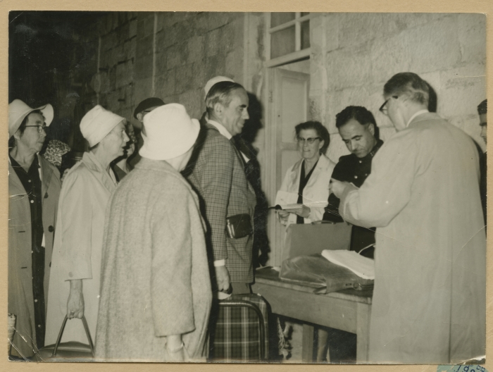 Checking the passports of the tourists passing through the Mandelbaum Gate