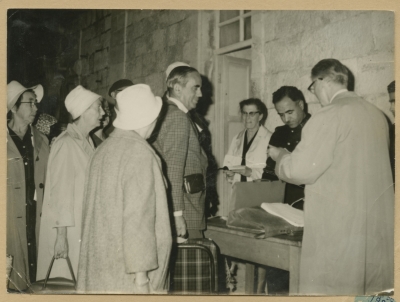 Checking the passports of the tourists passing through the Mandelbaum Gate