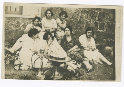 A Group of Women Drinking Coffee and Smoking Argeela 
