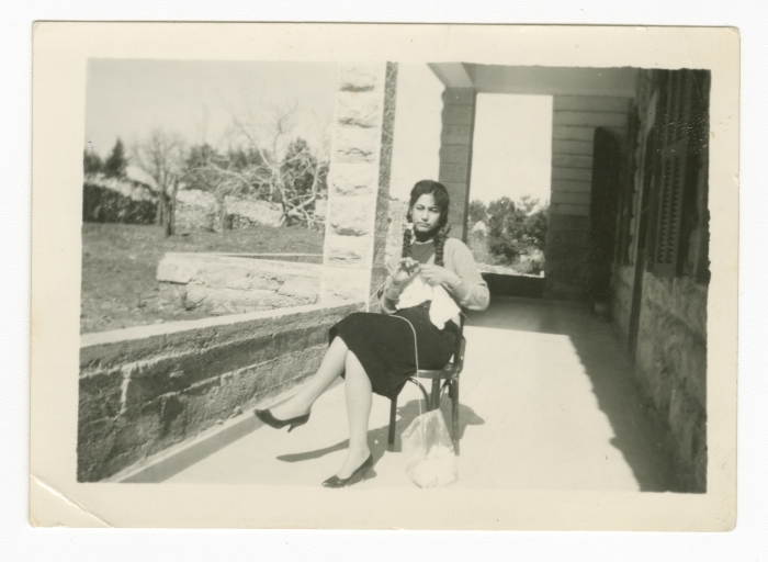 A Girl Knitting on her Porch 