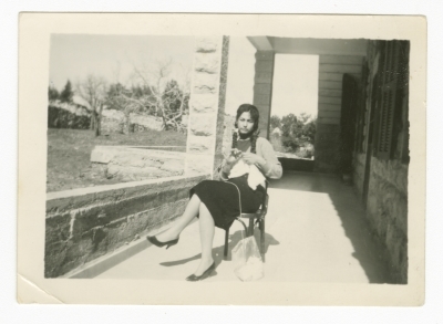 A Girl Knitting on her Porch 