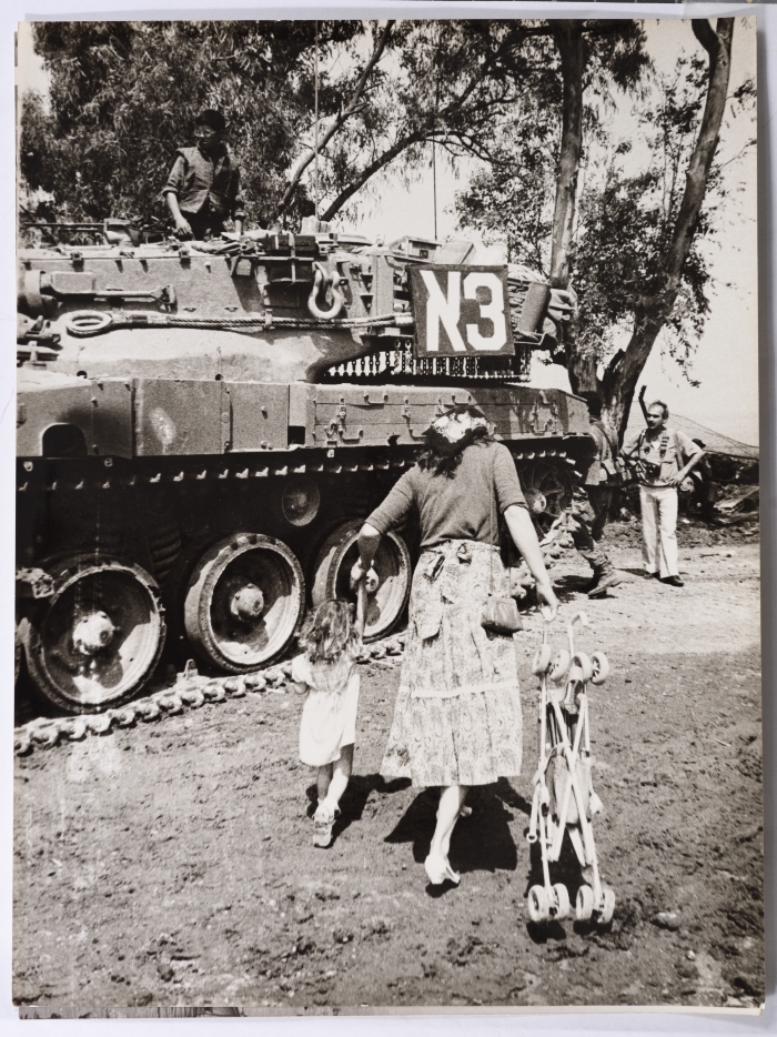 A Mother with her Daughter Next to a Zionist Military Vehicle in Southern Lebanon
