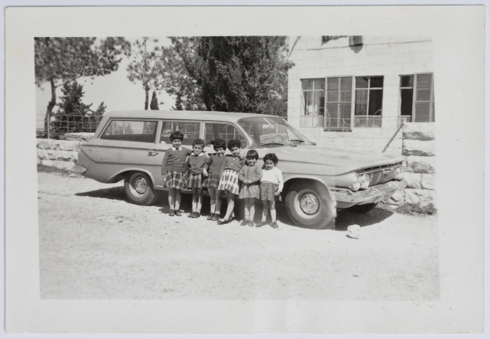 The Evangelical Home and School Students in Front of a Car in Ramallah
