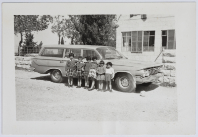 The Evangelical Home and School Students in Front of a Car in Ramallah
