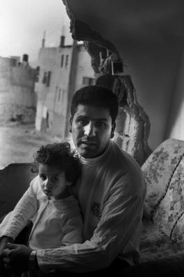 فلسطيني وطفلته في منزلهم المتضرر، مخيم جنين، حزيران 2002 