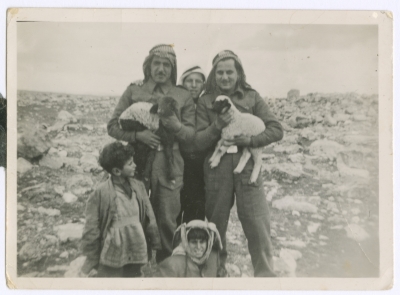 Two Military Personnel Holding Lambs, 1948