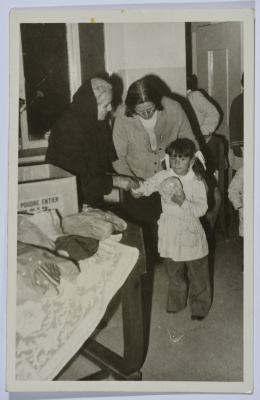 Handing gifts to a student from Dar al-Yatemat