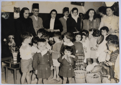 Head and Governing Body Members of the Arab Women Union Society with children during a celebration