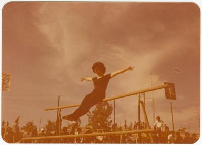 Cina Qassis Performing Gymnastics on a Beam, Birzeit College, 1974