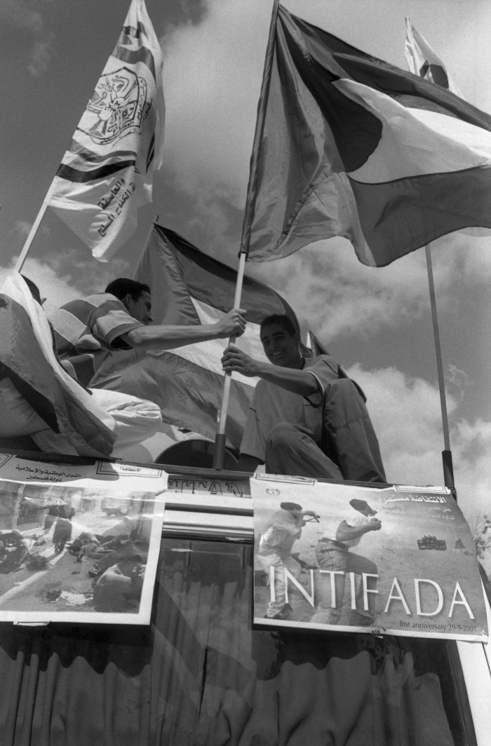 A Photograph of Two Young Men Holding the Palestinian Flag 